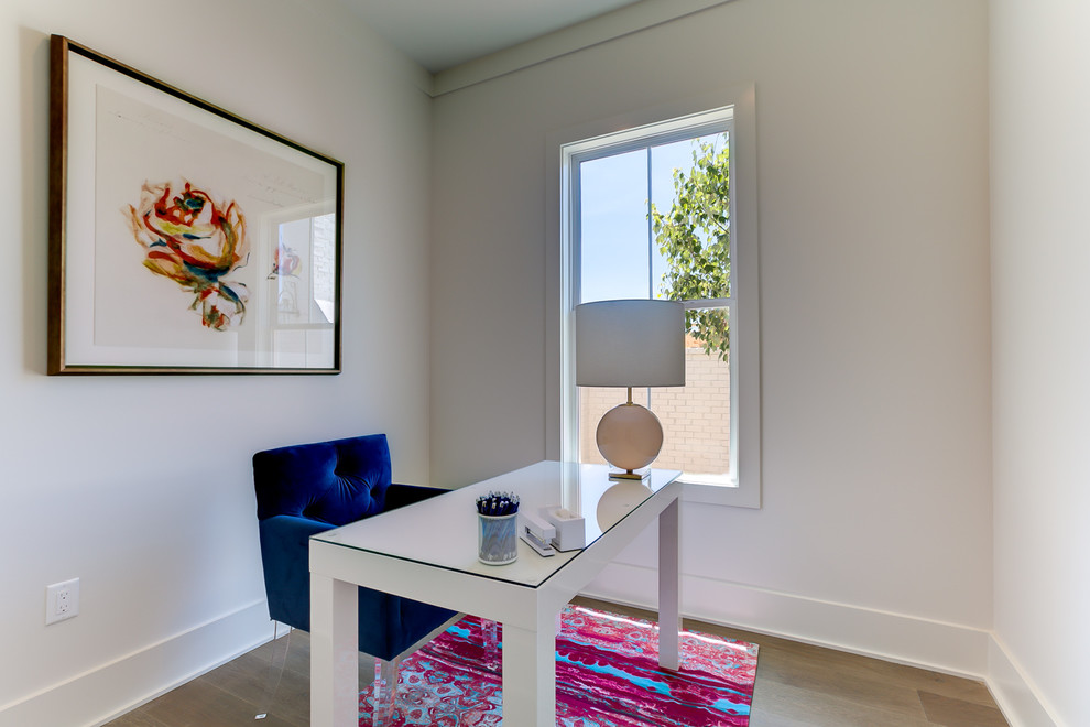 Photo of a small contemporary study in New Orleans with white walls, no fireplace and a freestanding desk.