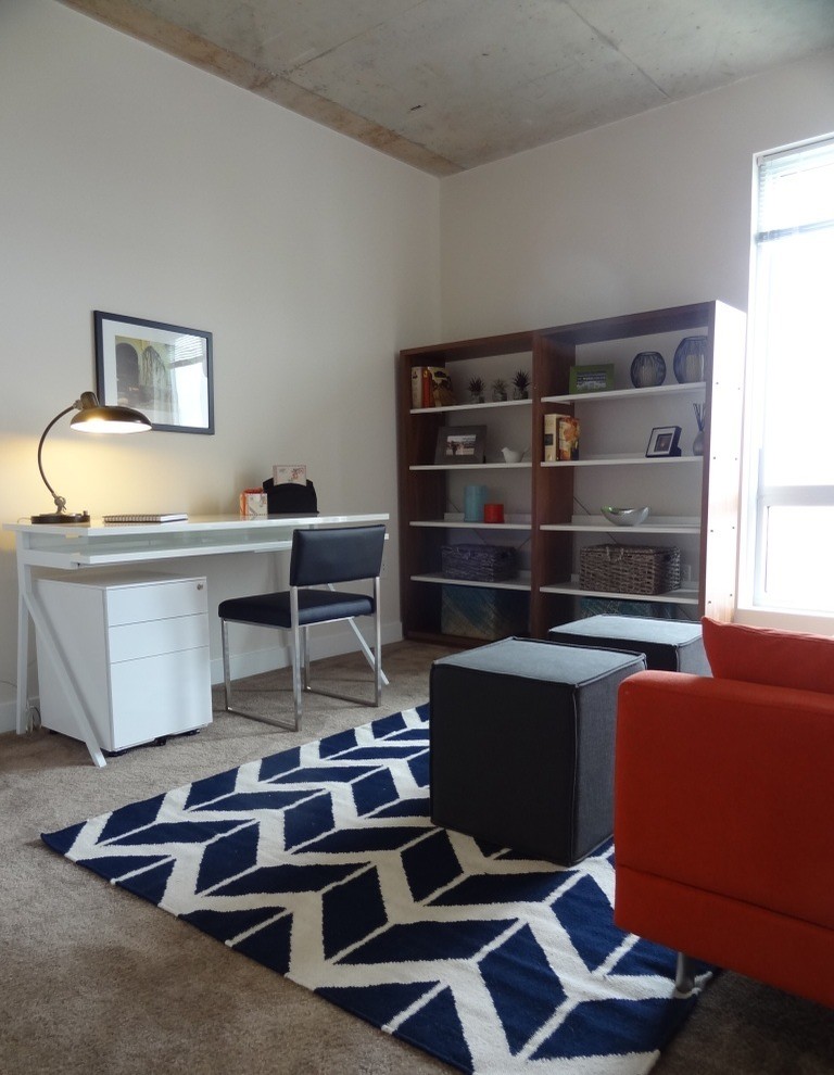 Example of a trendy freestanding desk carpeted home office design in Baltimore with white walls