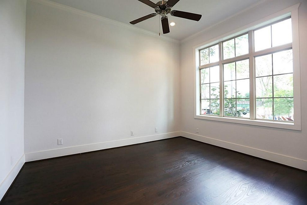 Inspiration for a mid-sized timeless dark wood floor study room remodel in Houston with beige walls and no fireplace