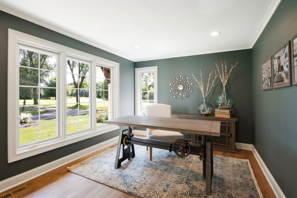 Inspiration för stora arbetsrum, med gröna väggar, mellanmörkt trägolv, ett fristående skrivbord och brunt golv