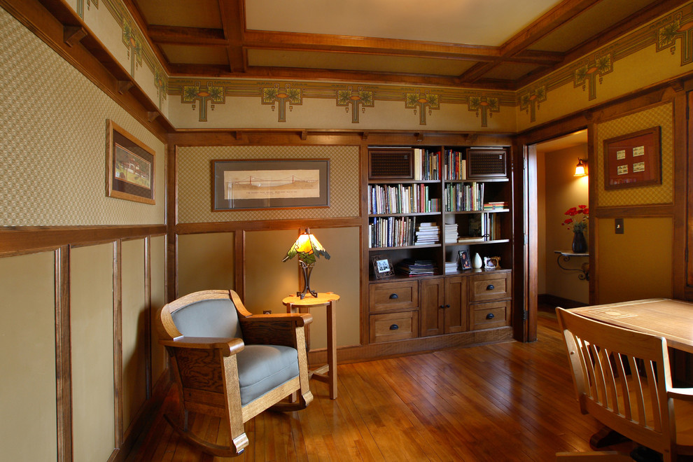 Example of an arts and crafts freestanding desk medium tone wood floor study room design in Minneapolis with brown walls