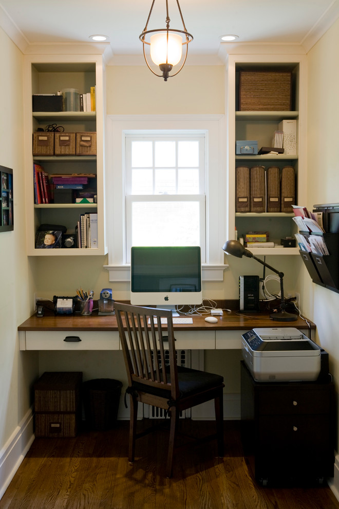 Modelo de despacho tradicional pequeño sin chimenea con paredes blancas, suelo de madera oscura y escritorio empotrado