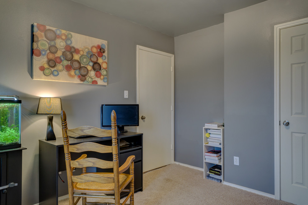 Medium sized traditional home office in Austin with grey walls, carpet and a freestanding desk.