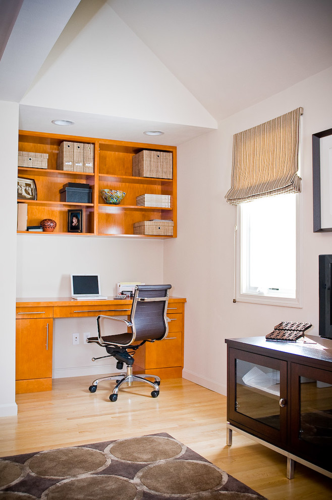 Example of a mid-sized trendy built-in desk light wood floor home studio design in Boston with beige walls and no fireplace