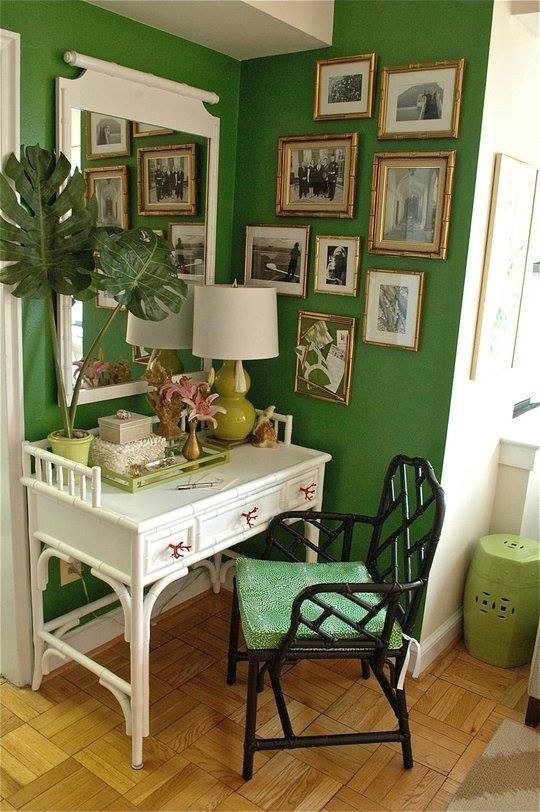 Photo of a small world-inspired study in DC Metro with green walls, light hardwood flooring and a freestanding desk.