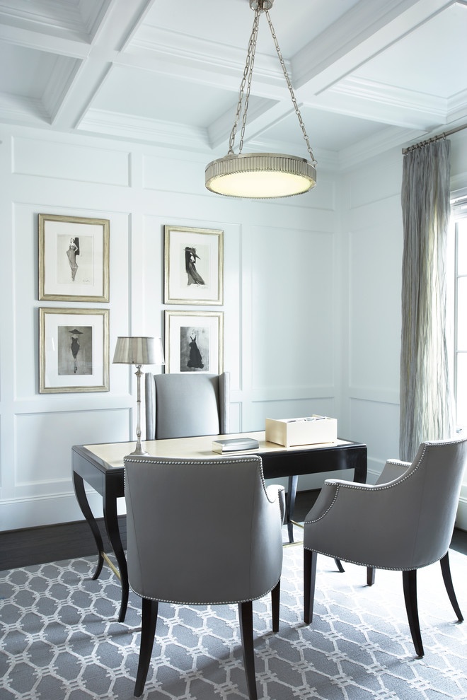 Elegant freestanding desk dark wood floor home office photo in Other with white walls