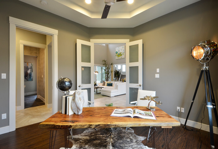 Mid-sized trendy freestanding desk bamboo floor home office photo in Austin with gray walls and no fireplace