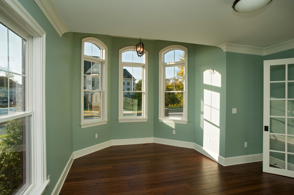 This is an example of a medium sized traditional study in Other with green walls and medium hardwood flooring.