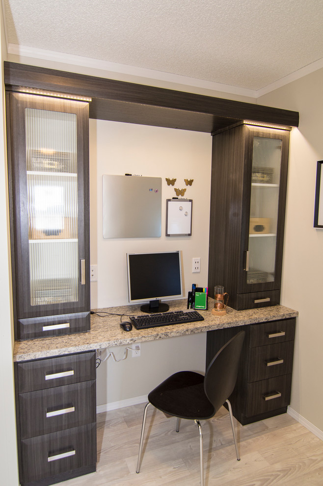 Photo of a small modern home office in Calgary with white walls, lino flooring and a built-in desk.