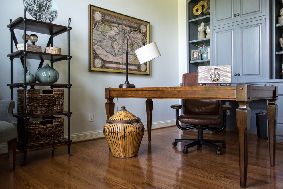 Mid-sized transitional freestanding desk medium tone wood floor and brown floor study room photo in Louisville with blue walls and no fireplace