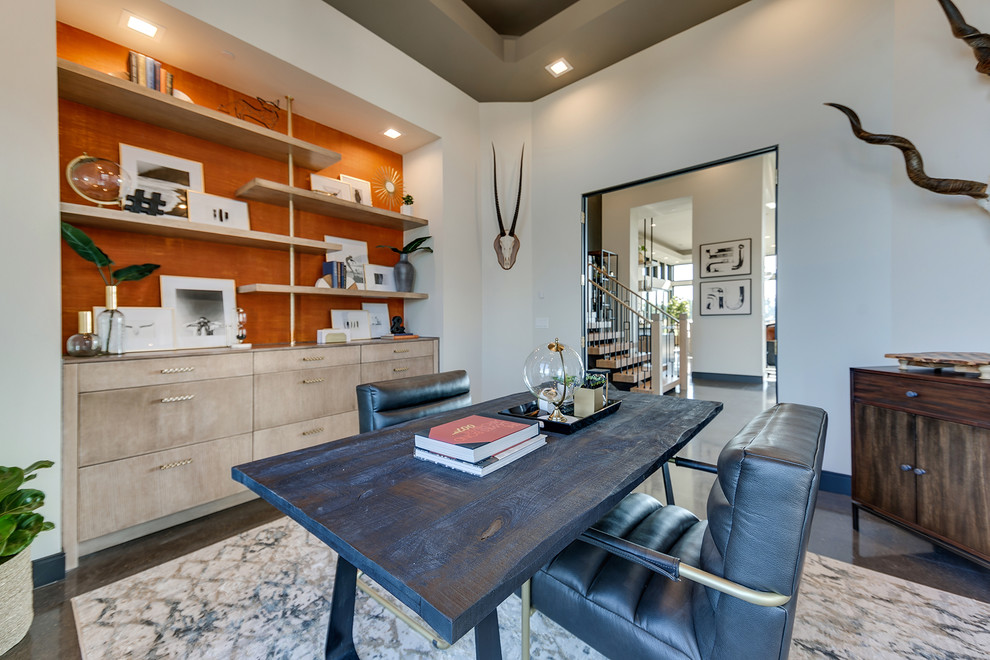 Medium sized contemporary study in Portland with white walls, concrete flooring, no fireplace, a freestanding desk and brown floors.