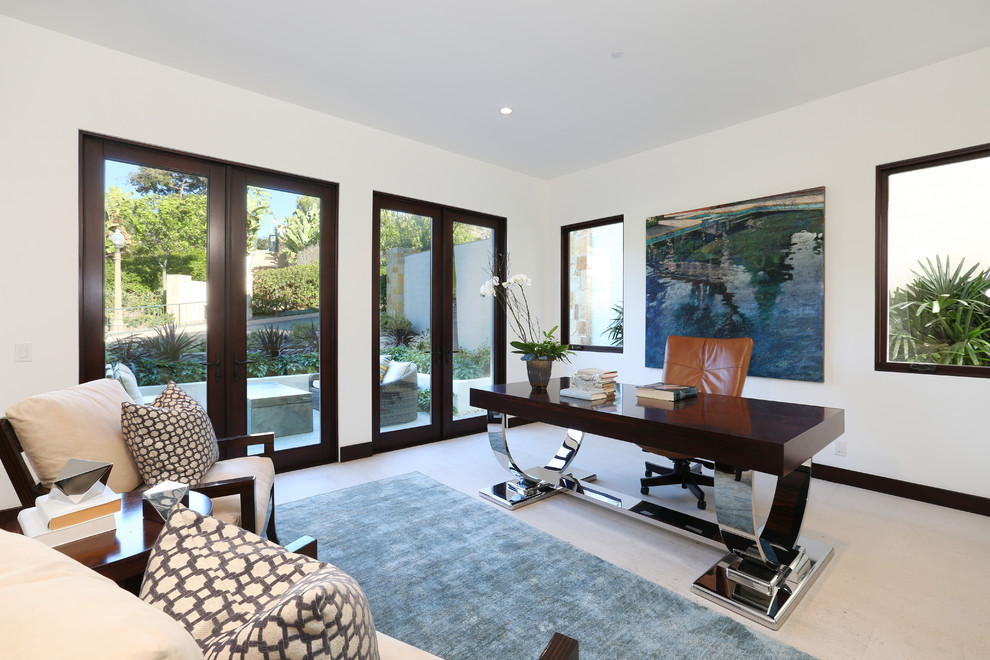 Example of a mid-sized transitional travertine floor home office design in Orange County with white walls