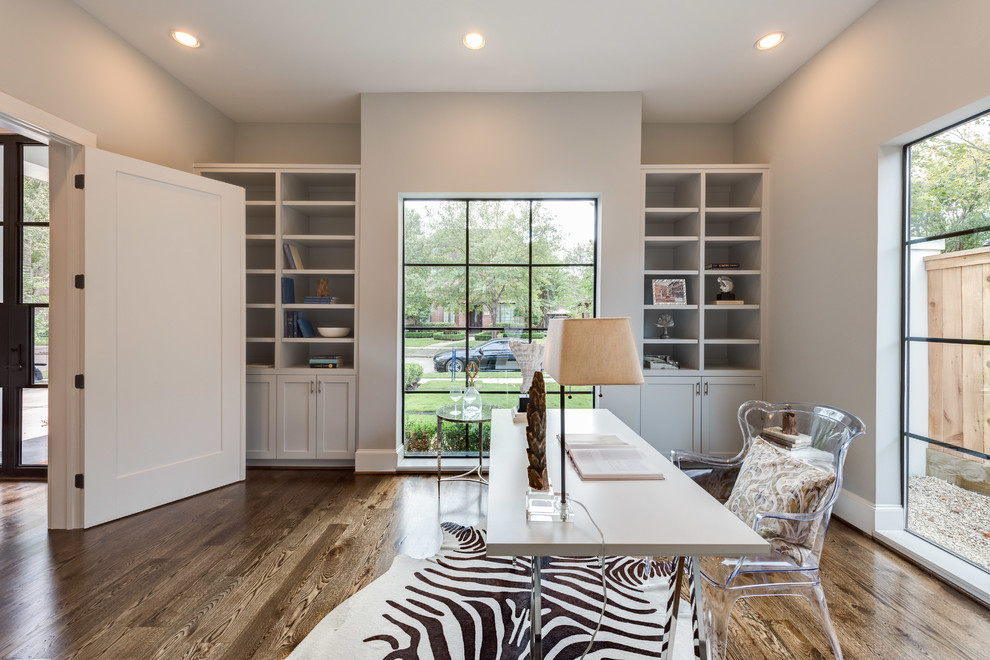 Large transitional medium tone wood floor home office photo in Houston with gray walls