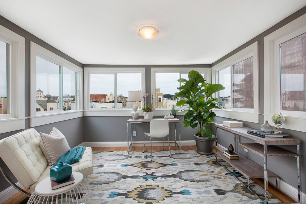 Example of a transitional freestanding desk medium tone wood floor home office design in San Francisco with gray walls and no fireplace