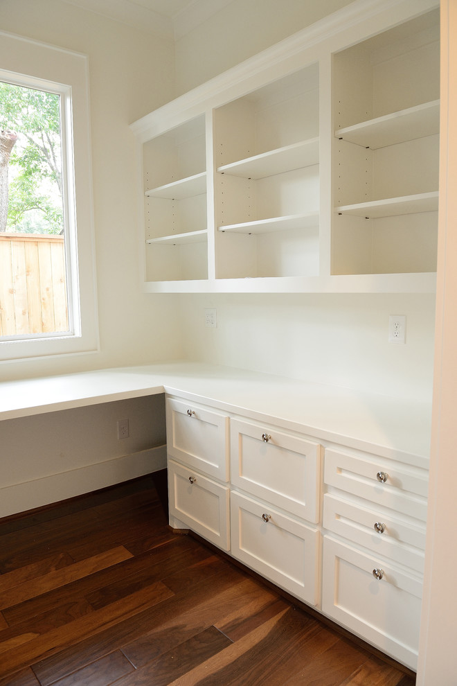 Photo of a medium sized classic study in Houston with white walls, medium hardwood flooring and a built-in desk.