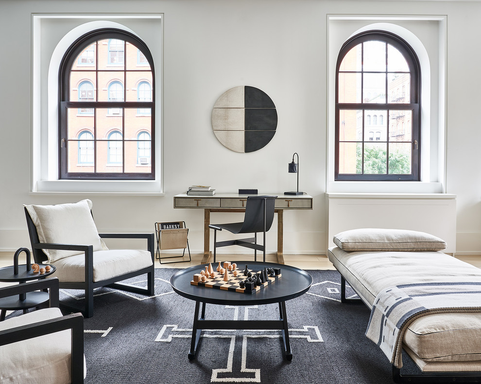 Scandinavian study in New York with white walls, light hardwood flooring, no fireplace and a freestanding desk.