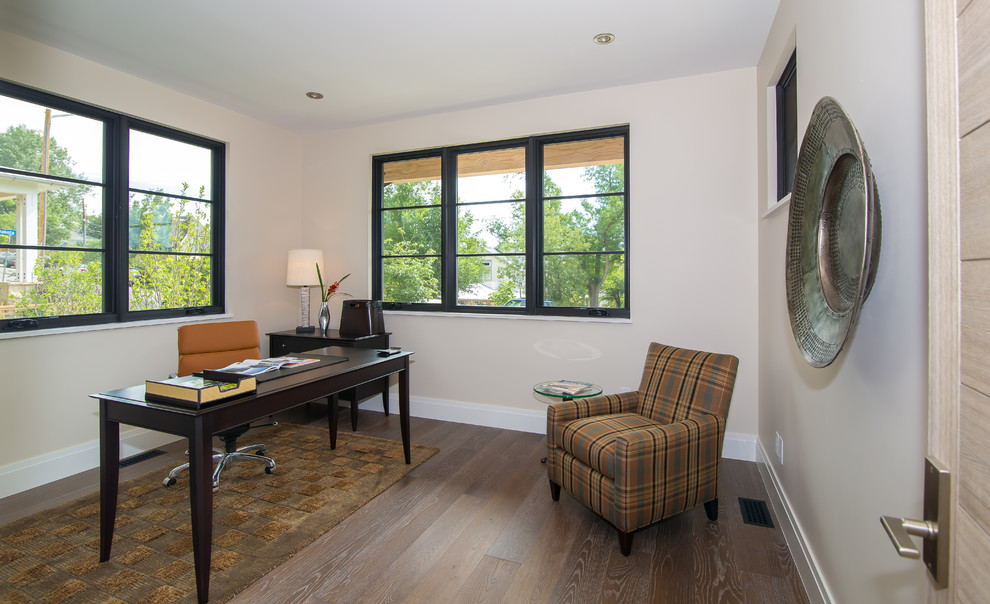 Photo of a medium sized modern study in Denver with beige walls, medium hardwood flooring, a freestanding desk and brown floors.