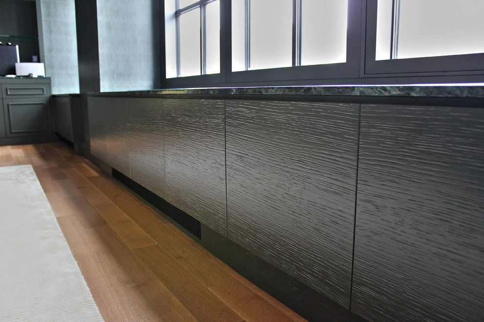 Imagen de despacho minimalista de tamaño medio con paredes verdes, suelo de madera clara y escritorio empotrado