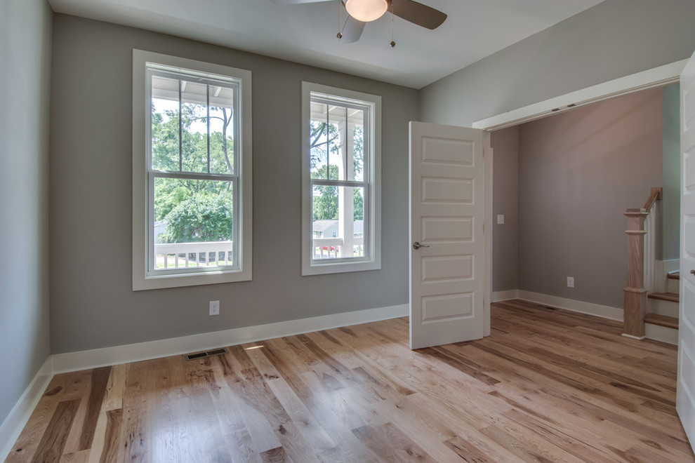 Mid-sized elegant light wood floor home office photo in Nashville with beige walls