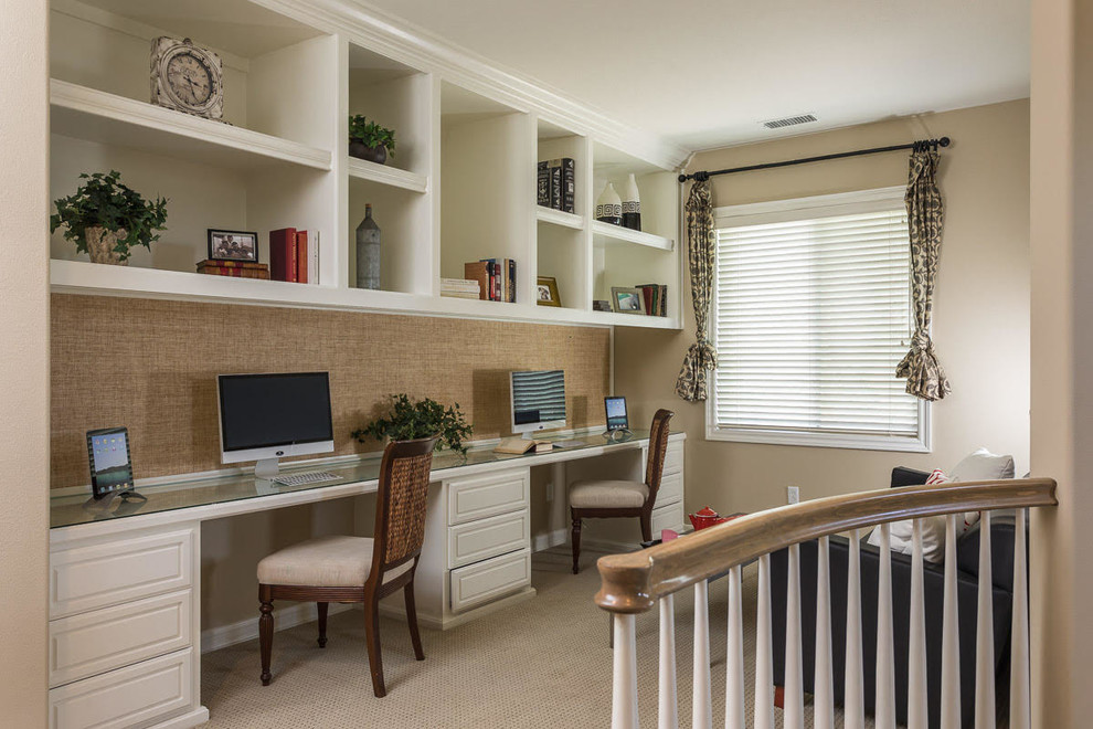 Example of a small classic built-in desk carpeted and beige floor study room design in Orange County with beige walls and no fireplace