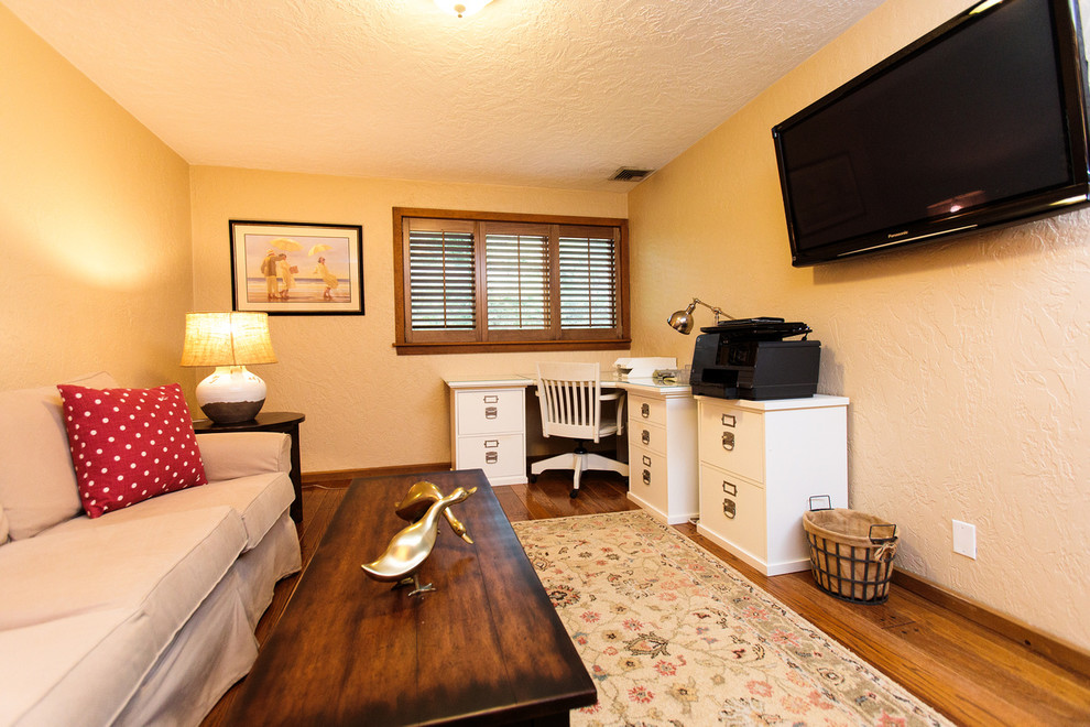 Cette image montre un bureau traditionnel de taille moyenne avec un mur beige, un sol en bois brun et un bureau indépendant.