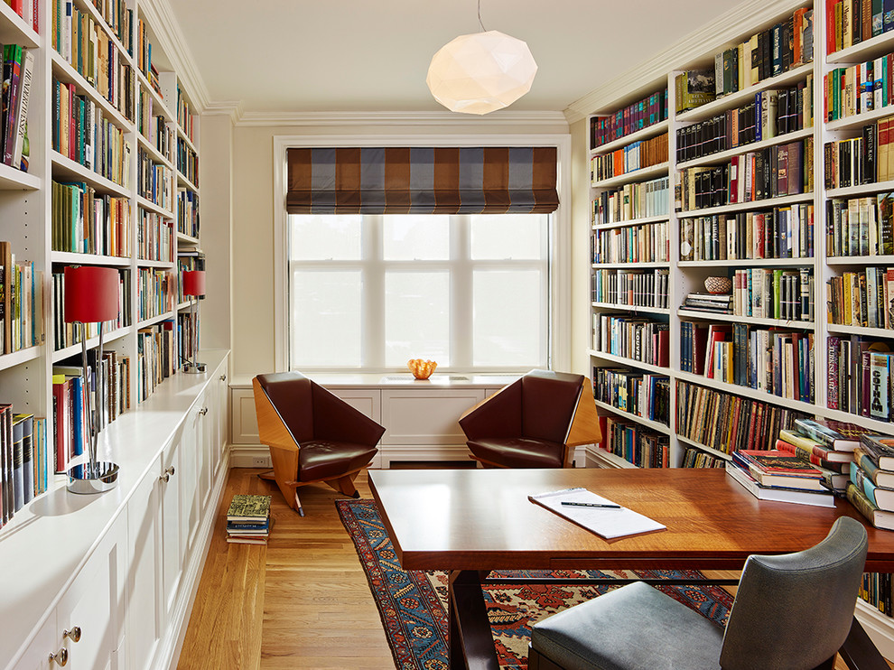 Photo of a medium sized contemporary study in New York with beige walls, medium hardwood flooring, no fireplace and a freestanding desk.