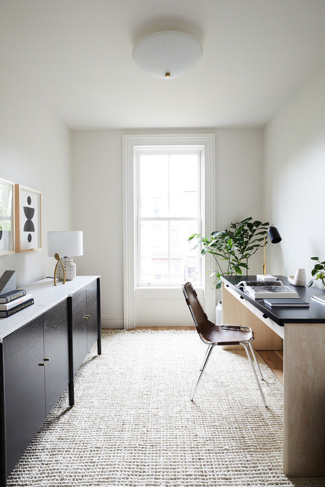 Inspiration for a transitional freestanding desk study room remodel in New York with white walls and no fireplace