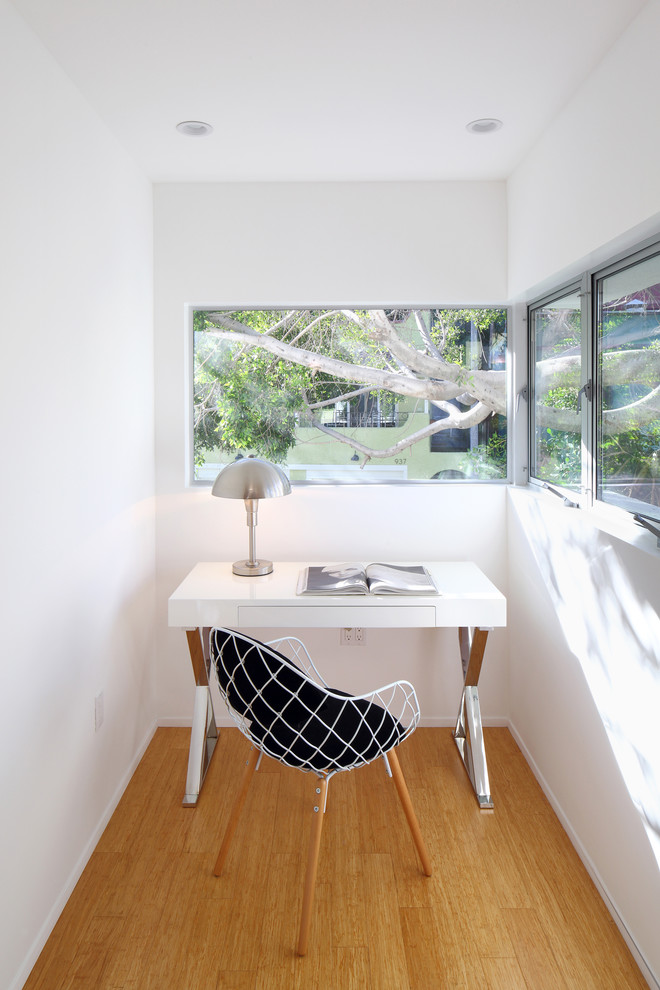 This is an example of a modern home office in Los Angeles with white walls.