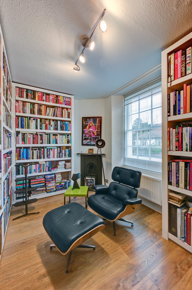 Photo of a large contemporary study in Devon with white walls and medium hardwood flooring.