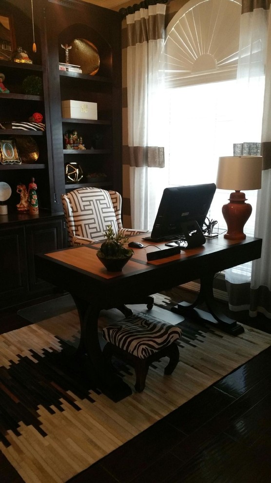 Example of a small eclectic freestanding desk dark wood floor study room design in Houston with beige walls