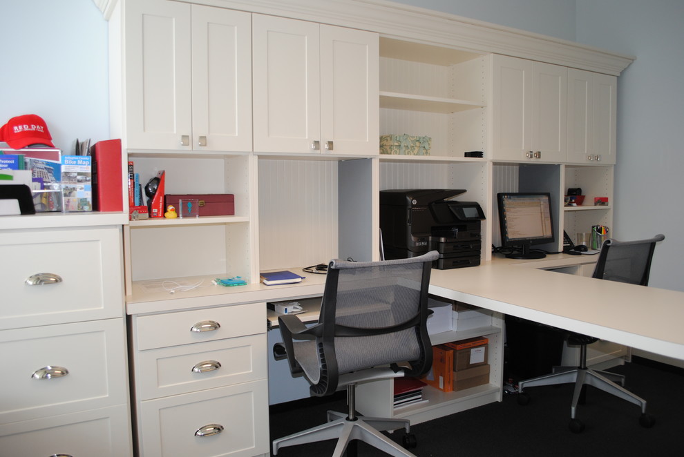 Example of a classic freestanding desk carpeted study room design in DC Metro with blue walls