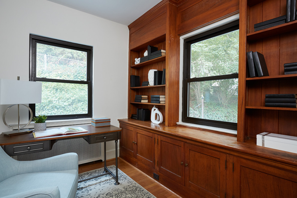 Small midcentury home office in DC Metro with a reading nook and a freestanding desk.