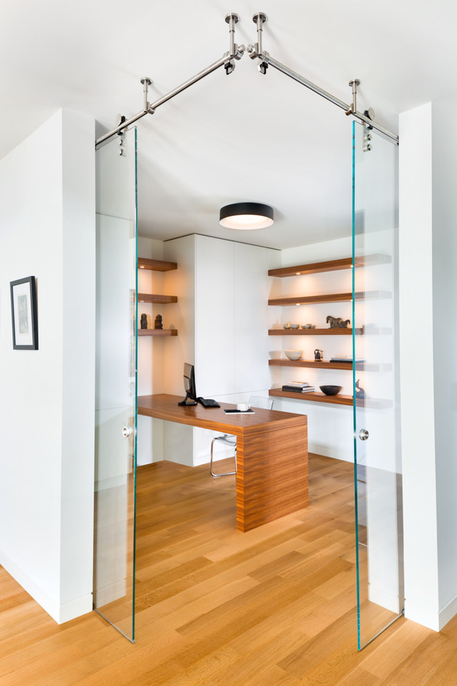 Ispirazione per un ufficio minimal con pareti bianche, pavimento in legno massello medio, scrivania incassata e pavimento marrone