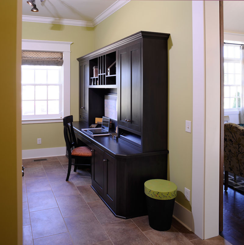 Inspiration for a timeless dark wood floor and beige floor mudroom remodel in Columbus with green walls