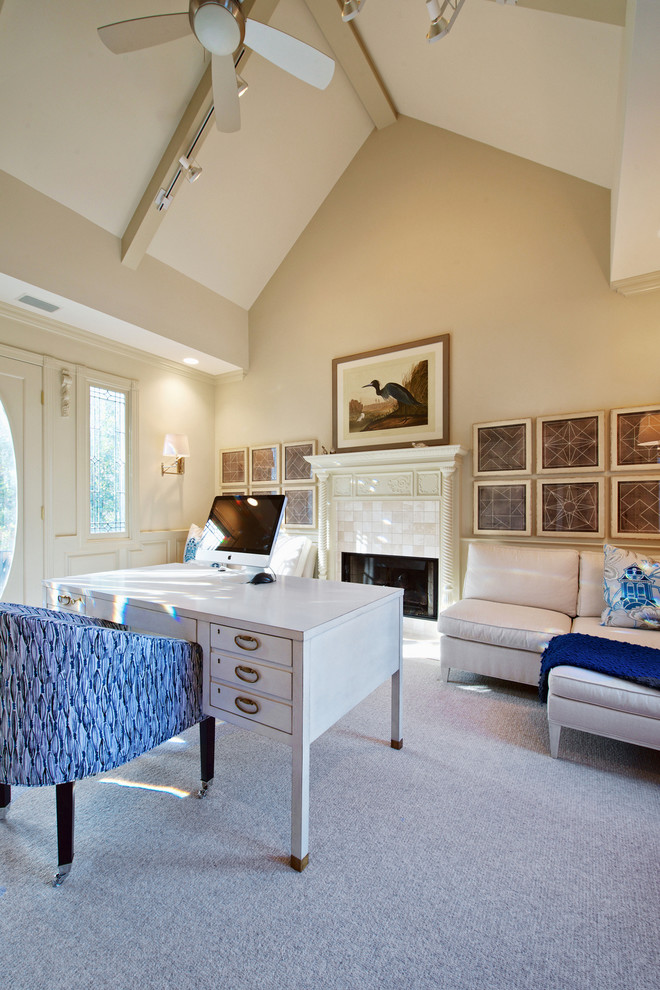 Study room - large traditional freestanding desk carpeted study room idea in Raleigh with beige walls, a standard fireplace and a tile fireplace