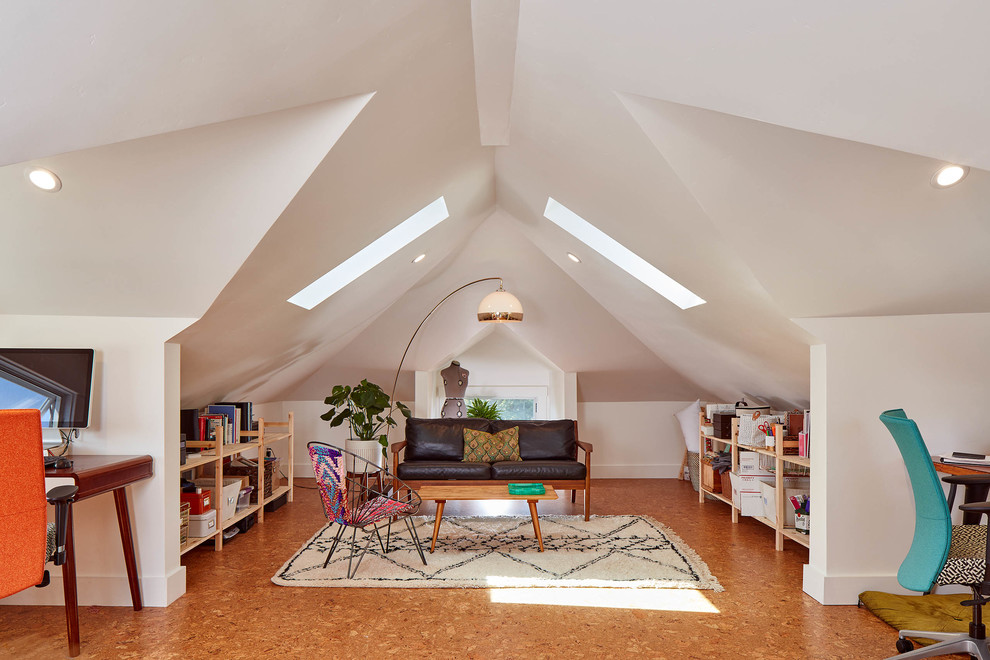 Idee per uno studio bohémian con pareti bianche, pavimento in sughero, scrivania autoportante e pavimento marrone
