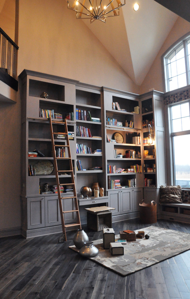 Home office library - huge transitional freestanding desk dark wood floor home office library idea in Milwaukee with beige walls