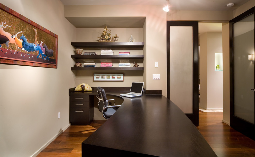 Inspiration for a contemporary built-in desk home office remodel in Orlando with beige walls