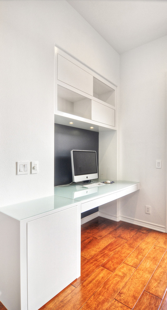 Idee per un grande ufficio moderno con pareti bianche, pavimento in legno massello medio, nessun camino e scrivania incassata