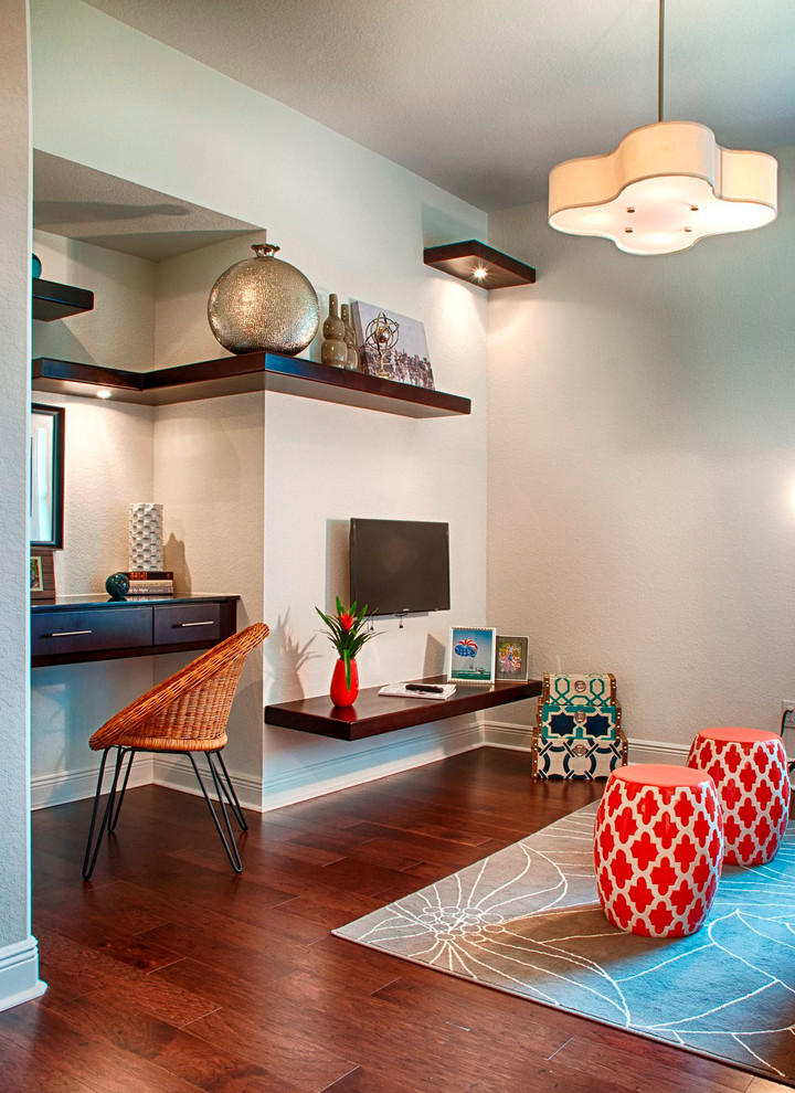 Example of a transitional built-in desk dark wood floor study room design in Miami with gray walls