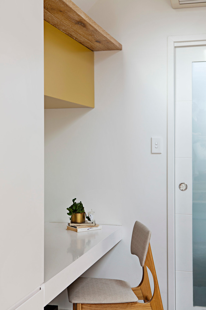Diseño de estudio contemporáneo pequeño con paredes blancas y escritorio empotrado