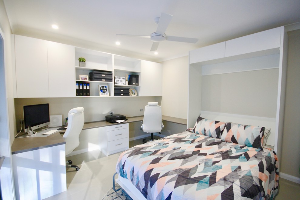 Example of a mid-sized minimalist built-in desk ceramic tile and beige floor study room design in Sydney with white walls