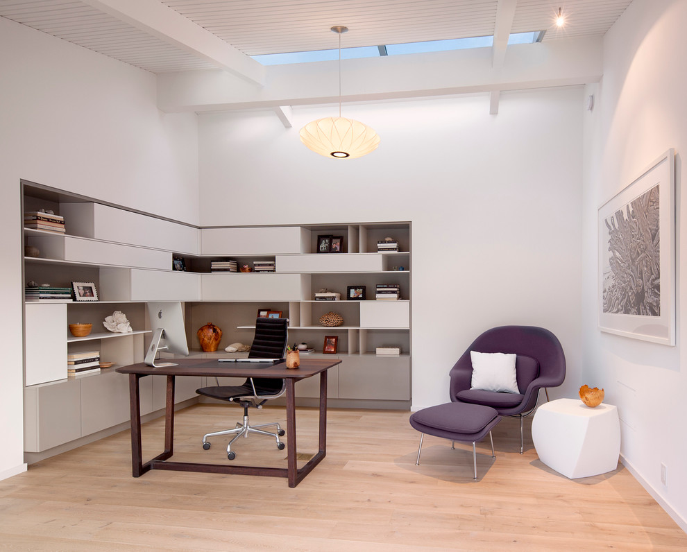 Example of a 1960s freestanding desk light wood floor and beige floor study room design in Santa Barbara with white walls and no fireplace