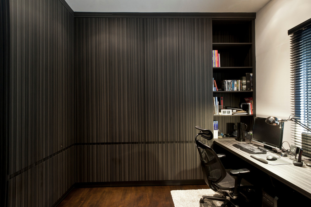 На фото: кабинет в стиле лофт с белыми стенами, темным паркетным полом и встроенным рабочим столом