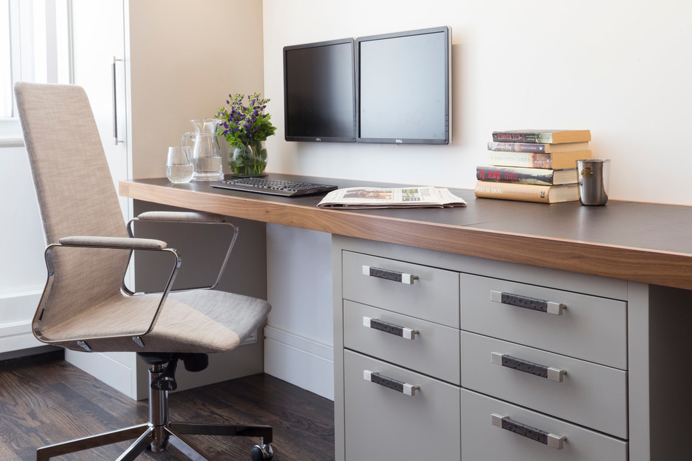 Inspiration pour un bureau design de taille moyenne avec un mur blanc, un sol en bois brun, aucune cheminée, un bureau intégré et un sol marron.