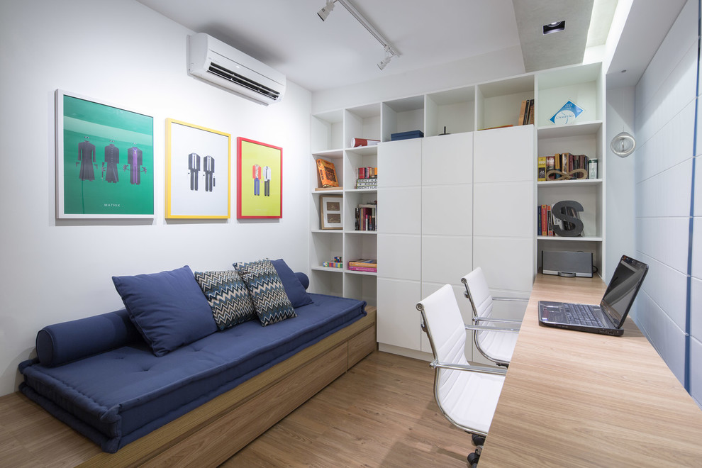 Immagine di uno studio minimal con pareti bianche, pavimento in legno massello medio e scrivania incassata