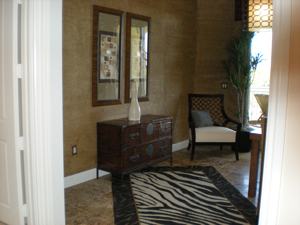 Example of a mid-sized eclectic built-in desk marble floor study room design in Miami with brown walls