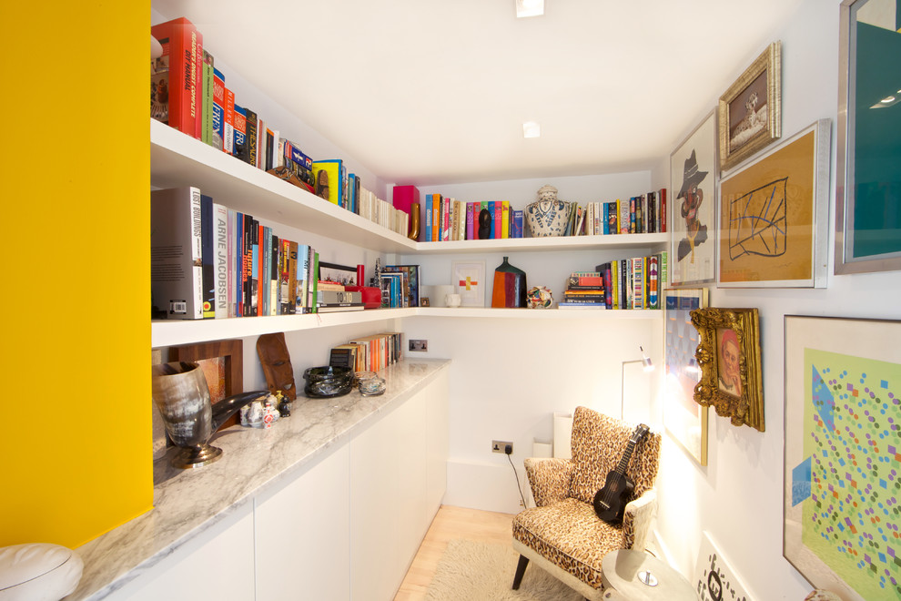 Photo of a contemporary study in London with white walls and light hardwood flooring.
