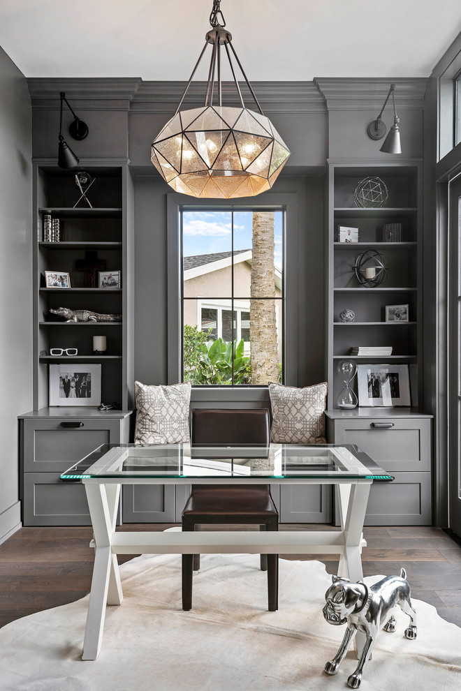 Example of a mid-sized transitional freestanding desk brown floor and dark wood floor study room design in Orlando with gray walls