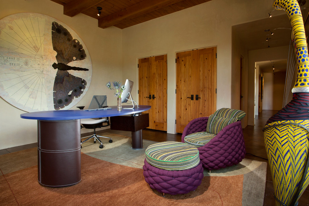 Tuscan freestanding desk study room photo in Albuquerque with beige walls